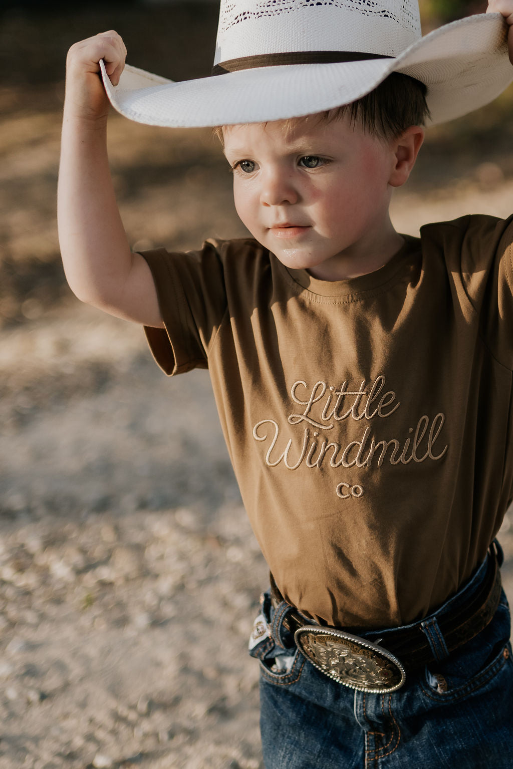 LIMITED EDITION embroidered kids tee dust brown front view showing signature LWCC logo on warm dusty brown