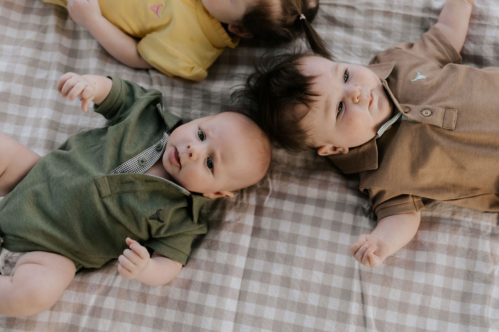 Ky Baby khaki green polo romper snap detail showing easy nappy change access