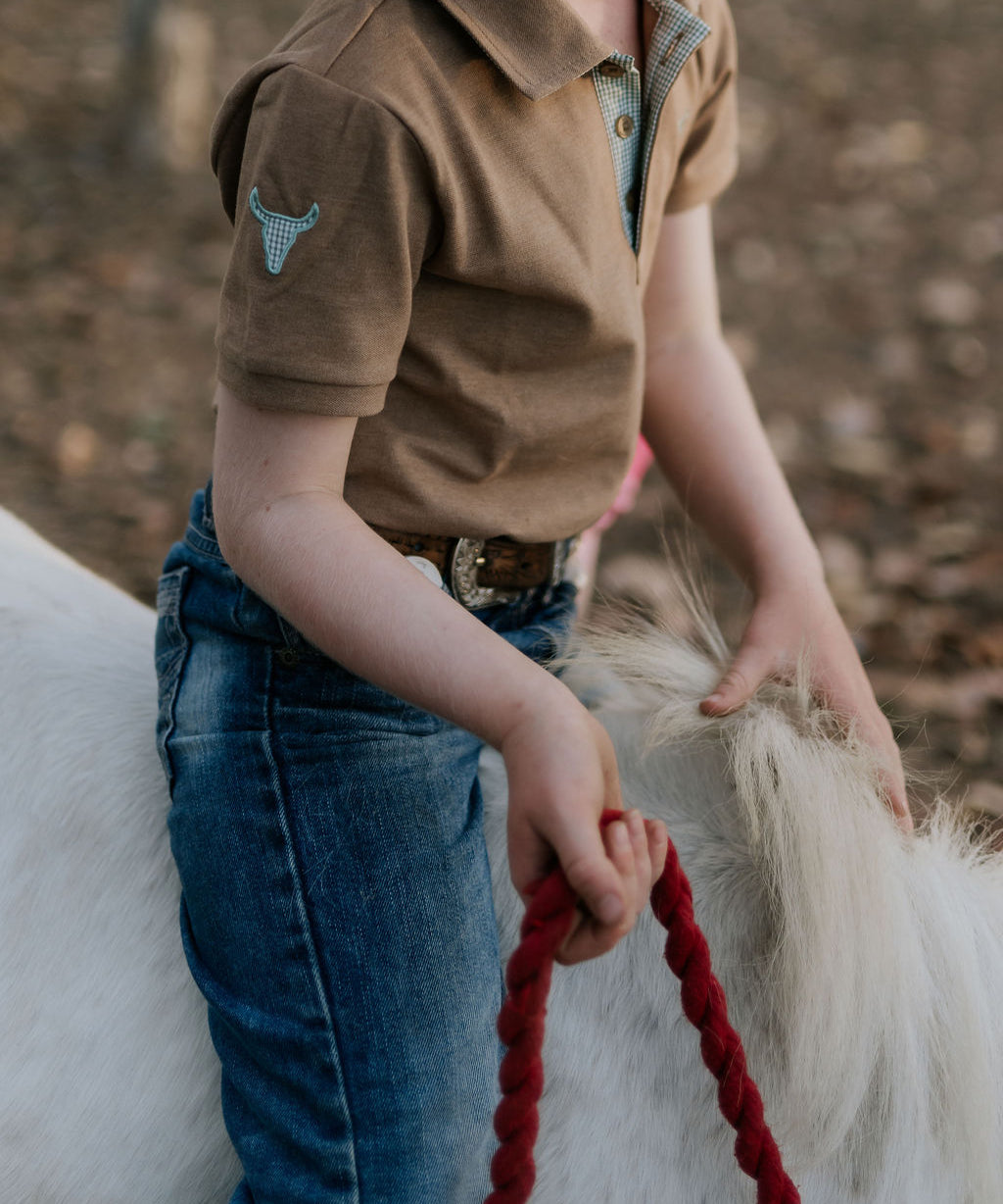 Clayton caramel boy's polo worn by boy showing smart casual country style in warm tones