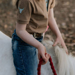 Clayton caramel boy's polo worn by boy showing smart casual country style in warm tones