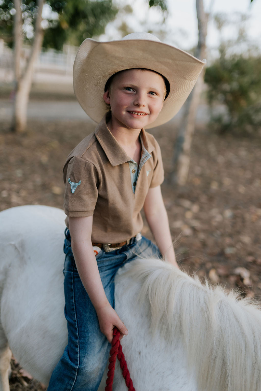 Clayton caramel boy's polo front view showing classic polo style in warm caramel tone for boys