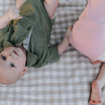 Kiki Baby pink polo romper snap detail showing easy nappy change access