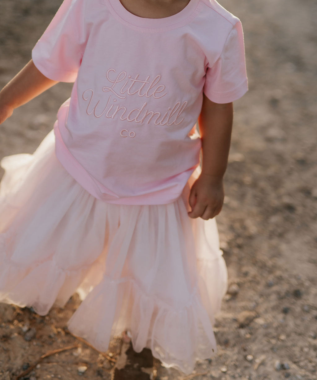 LIMITED EDITION embroidered kids tee soft pink front view showing signature LWCC embroidered logo on soft pink
