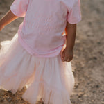 LIMITED EDITION embroidered kids tee soft pink front view showing signature LWCC embroidered logo on soft pink