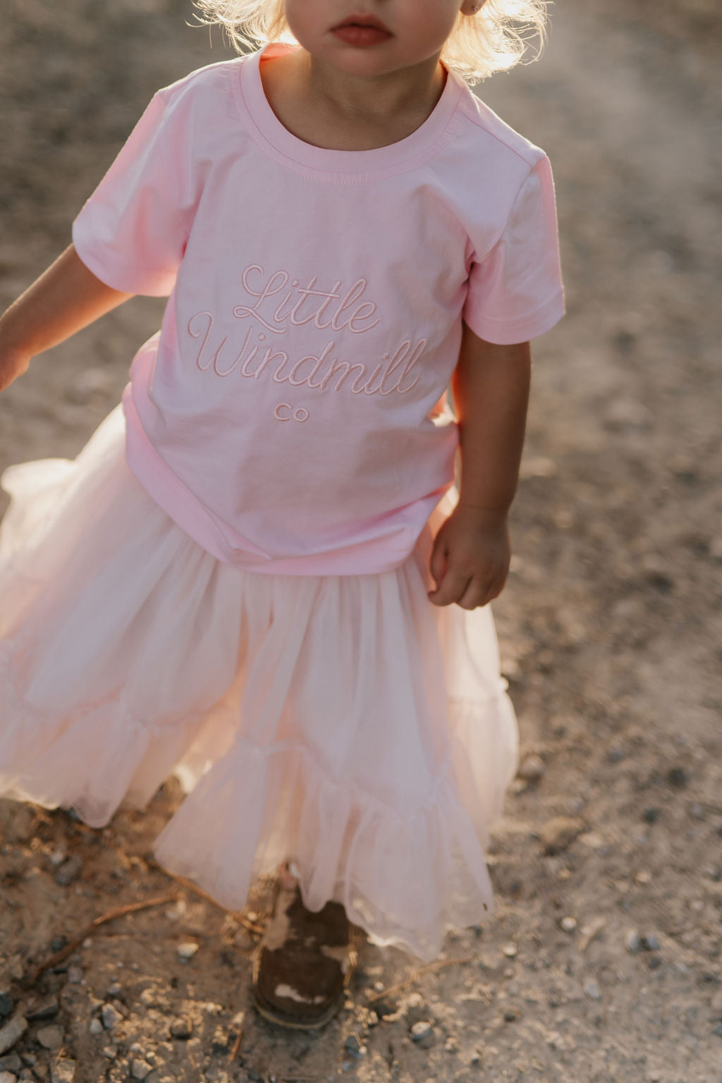 LIMITED EDITION embroidered kids tee soft pink front view showing signature LWCC embroidered logo on soft pink