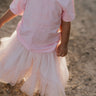 LIMITED EDITION embroidered kids tee soft pink front view showing signature LWCC embroidered logo on soft pink