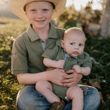 Ky Baby khaki green polo romper back view showing snap button closure and khaki green colourway