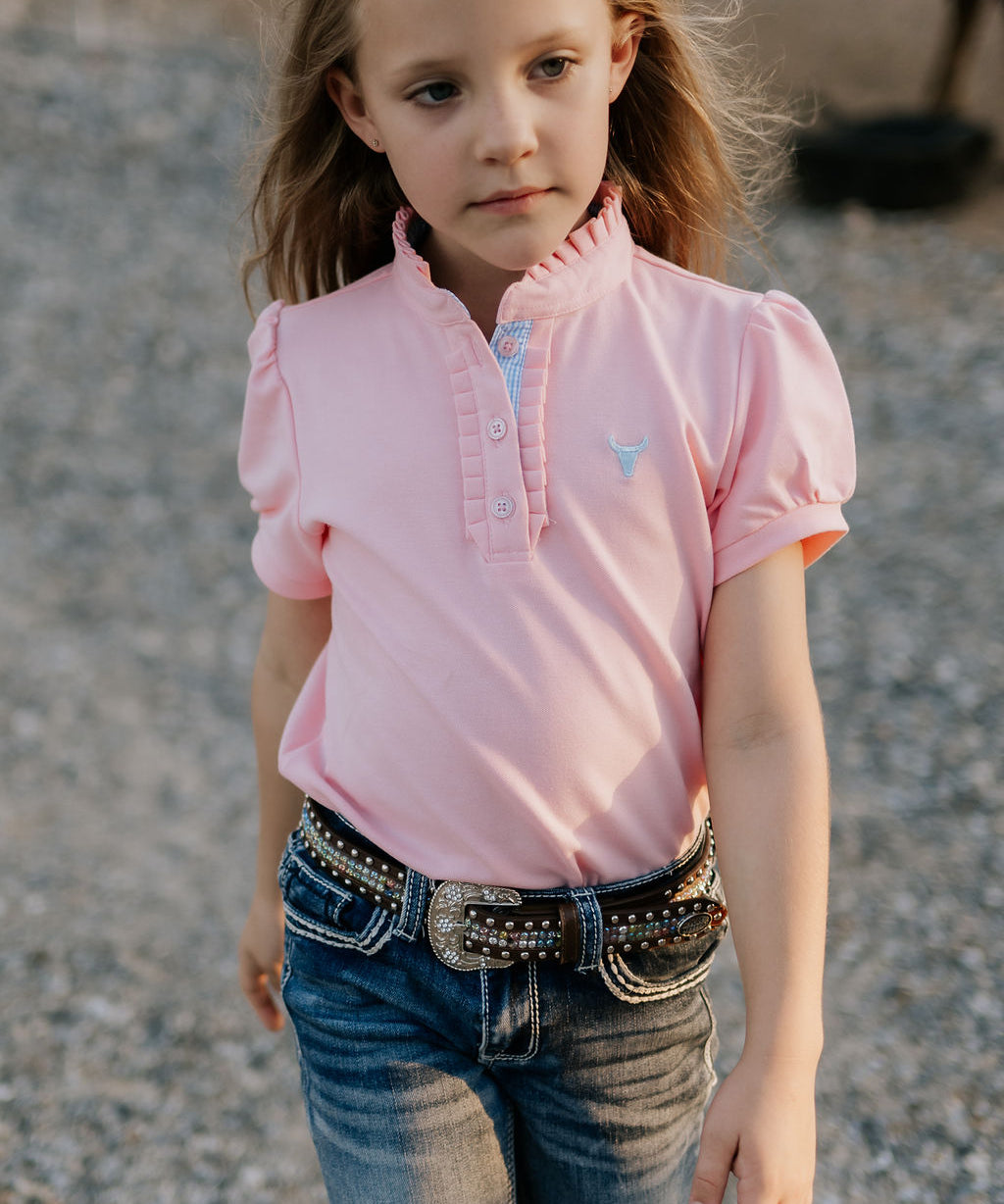 Keira baby pink ruffle polo front view showing beautiful ruffle collar in soft baby pink with feminine detail