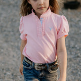Keira baby pink ruffle polo front view showing beautiful ruffle collar in soft baby pink with feminine detail