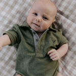 Ky Baby khaki green baby polo romper front view showing earthy khaki green polo collar romper with snap buttons