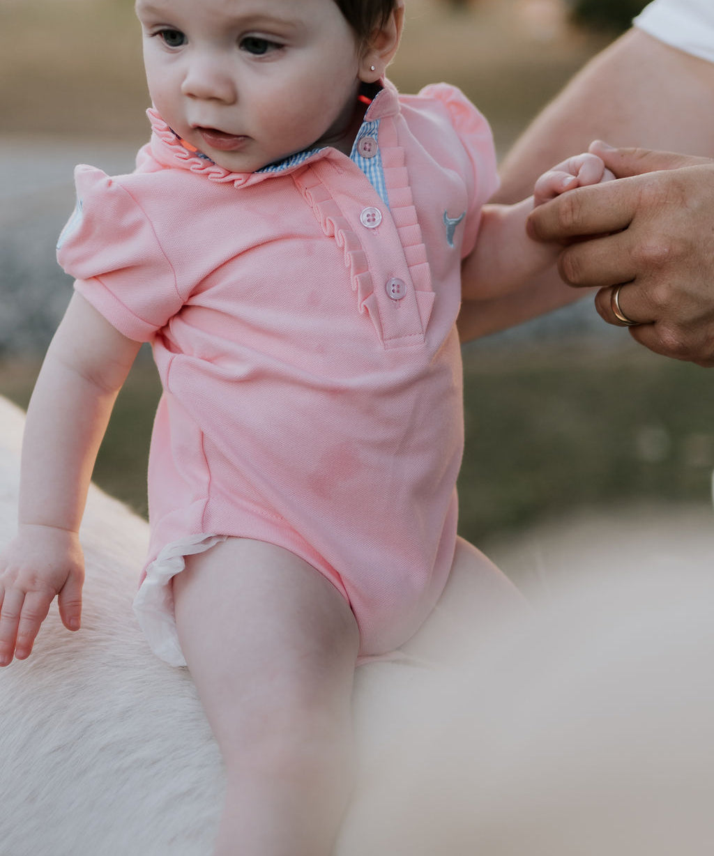 Kiki Baby baby pink polo romper front view showing adorable pink polo collar romper with snap buttons