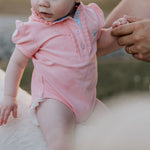 Kiki Baby baby pink polo romper front view showing adorable pink polo collar romper with snap buttons