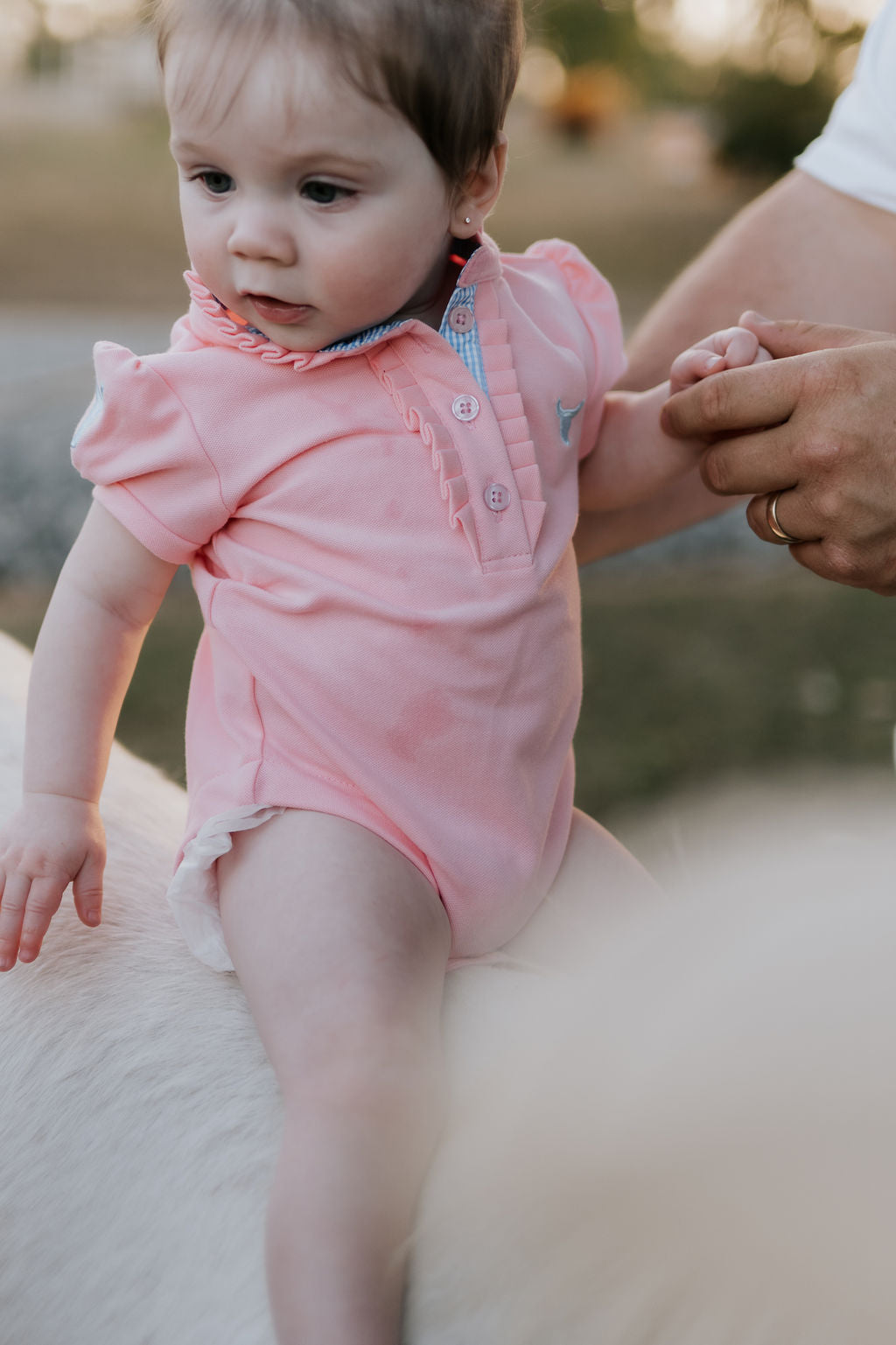 Kiki Baby baby pink polo romper front view showing adorable pink polo collar romper with snap buttons