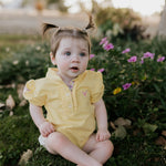 Larrisa Baby butter yellow polo romper front view showing cheerful butter yellow polo collar romper with snap buttons