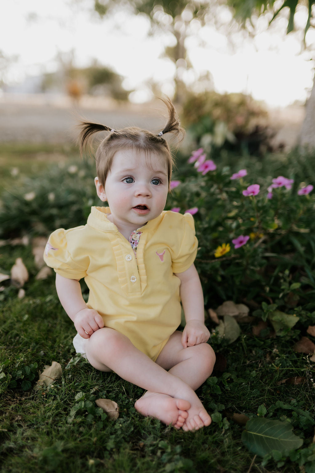 Larrisa Baby butter yellow polo romper front view showing cheerful butter yellow polo collar romper with snap buttons