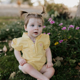 Larrisa Baby butter yellow polo romper front view showing cheerful butter yellow polo collar romper with snap buttons