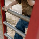 LIMITED EDITION embroidered kids tee dust brown flat lay showing full design and warm colourway