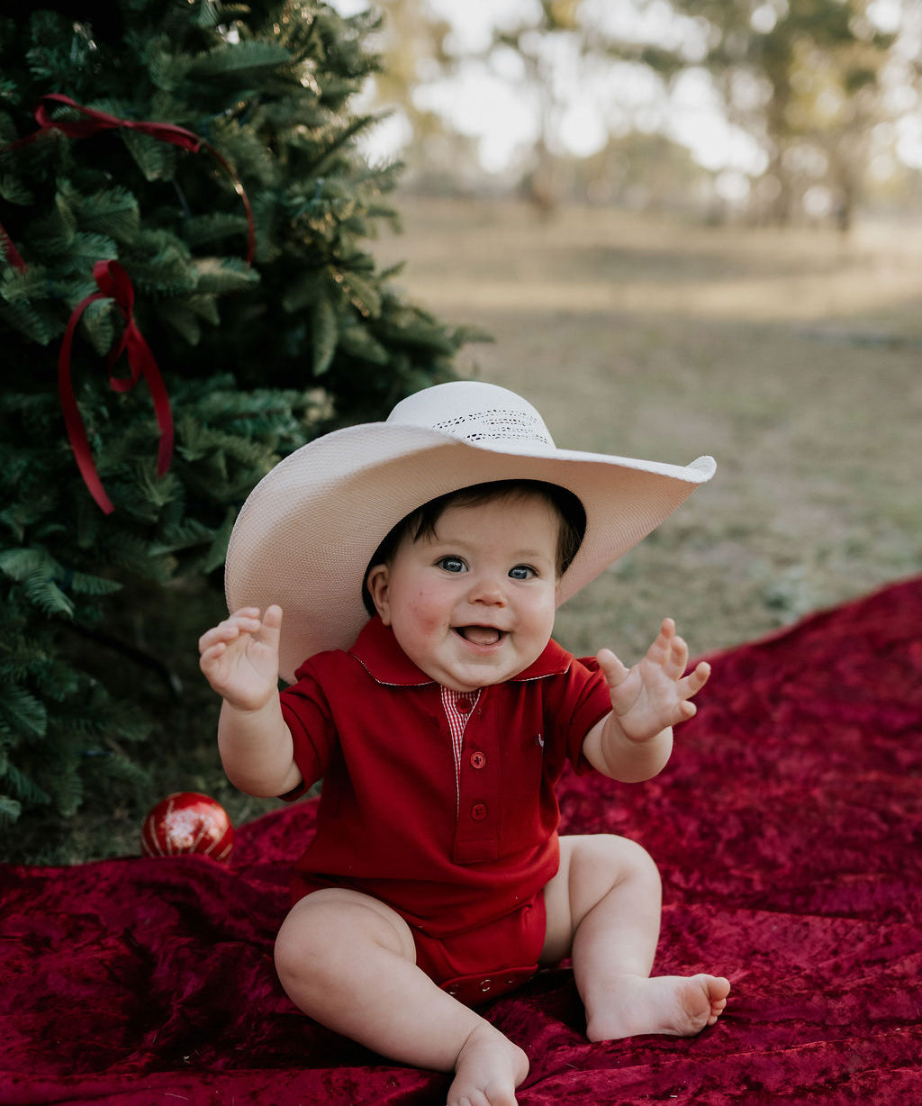 Nicco Baby deep red polo romper back view showing snap closure and cute baby fit