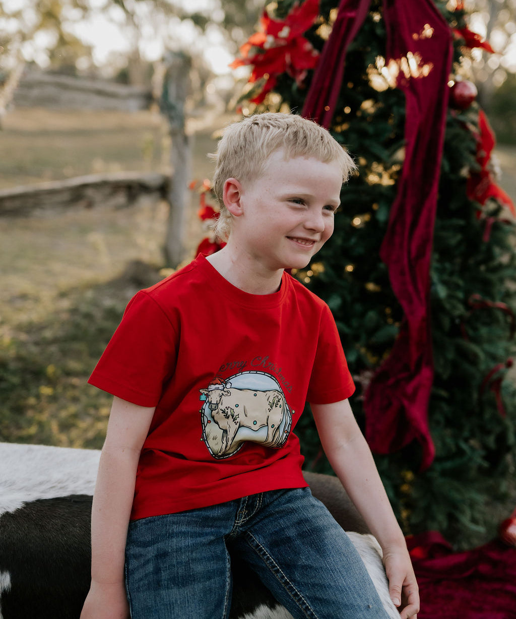 Western printed Christmas cow tee worn showing fun festive Christmas cow graphic on quality tee