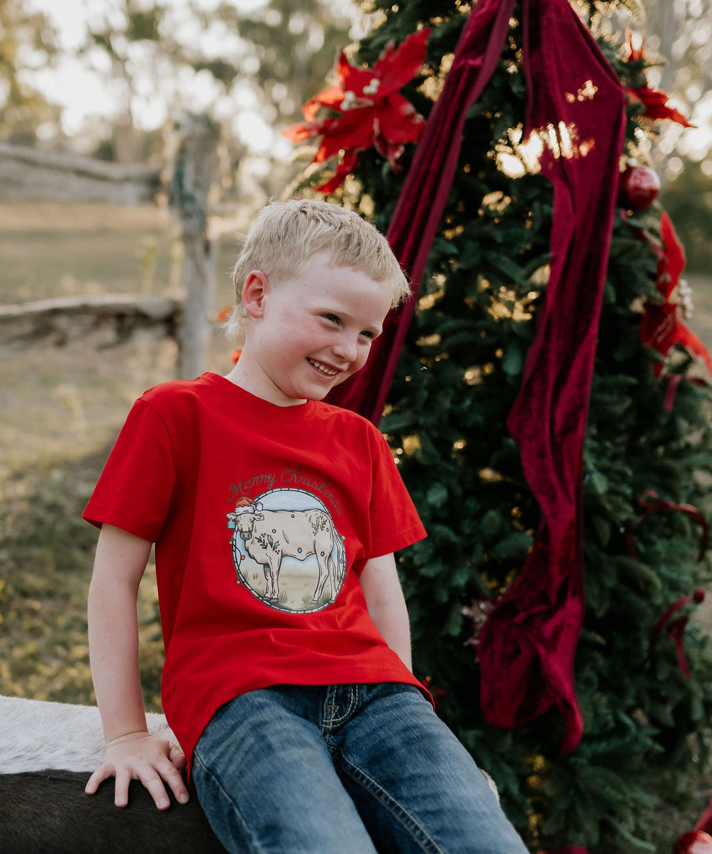 Western printed Christmas cow tee front view showing festive Christmas cow and western holiday print