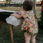Faith floral scallop short sleeve romper front view showing sweet floral print scalloped romper for girls