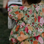 Faith floral scallop short sleeve romper flatlay showing full floral design and scallop details