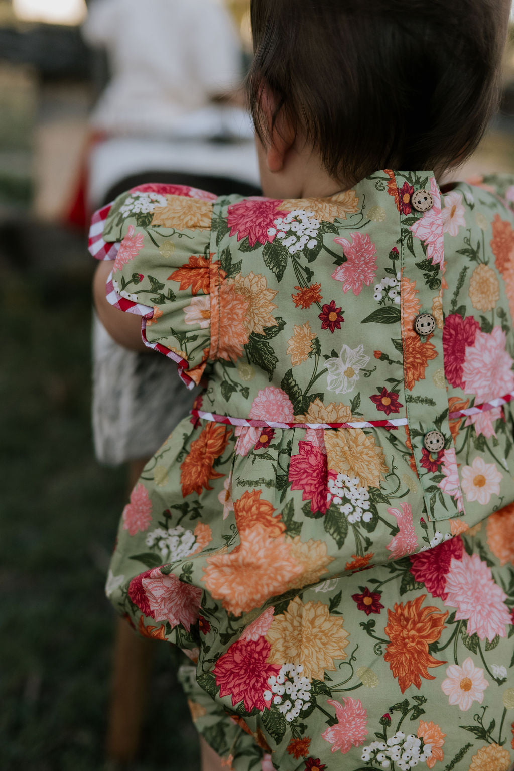 Faith floral scallop short sleeve romper flatlay showing full floral design and scallop details