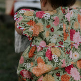 Faith floral scallop short sleeve romper flatlay showing full floral design and scallop details