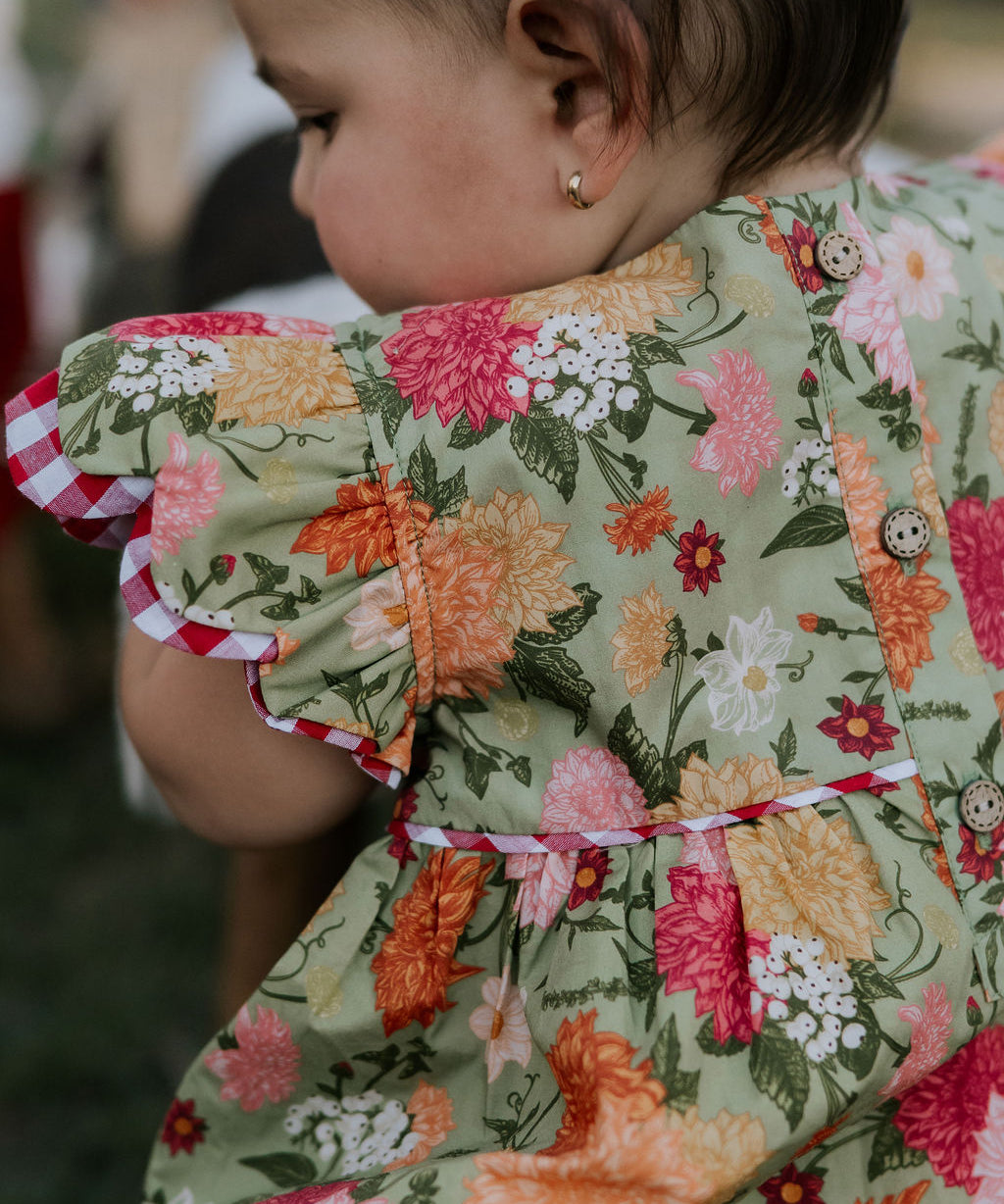 Faith floral scallop short sleeve romper back view showing scalloped hem and floral print detail