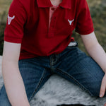 Nick deep red boys polo shirt flatlay showing full polo design in deep red