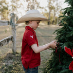 Deep red polo shirt worn showing smart country casual style in rich deep red colourway