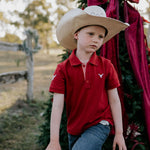 Nick deep red boys polo shirt back view showing neat polo fit in rich deep red