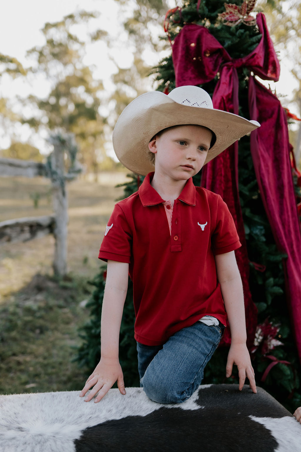 Nick deep red boys polo shirt back view showing neat polo fit in rich deep red