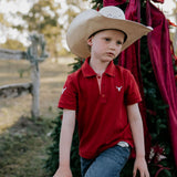 Nick deep red boys polo shirt back view showing neat polo fit in rich deep red