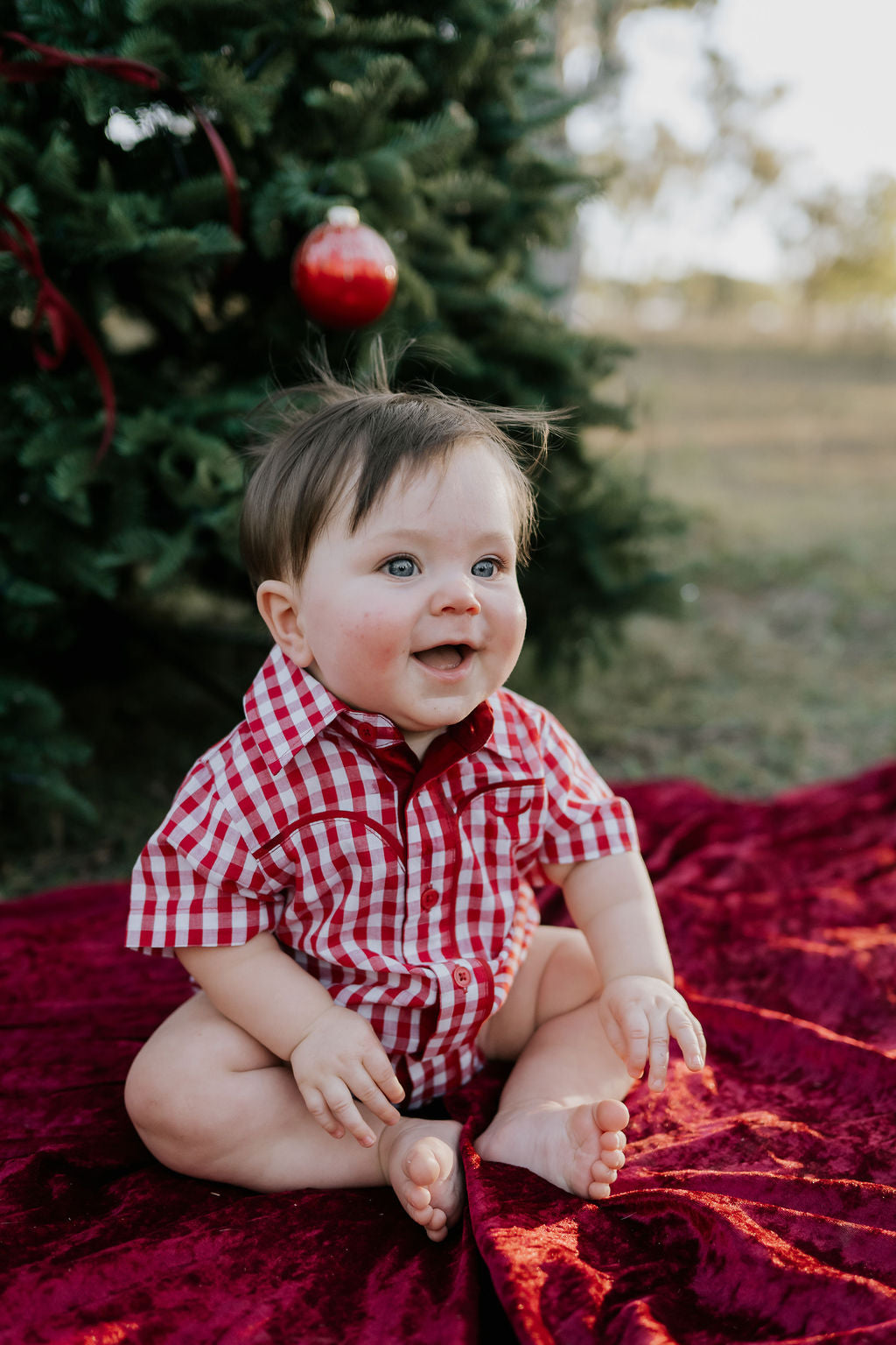 Barnley deep red checked short sleeve romper flatlay showing full romper design in deep red check