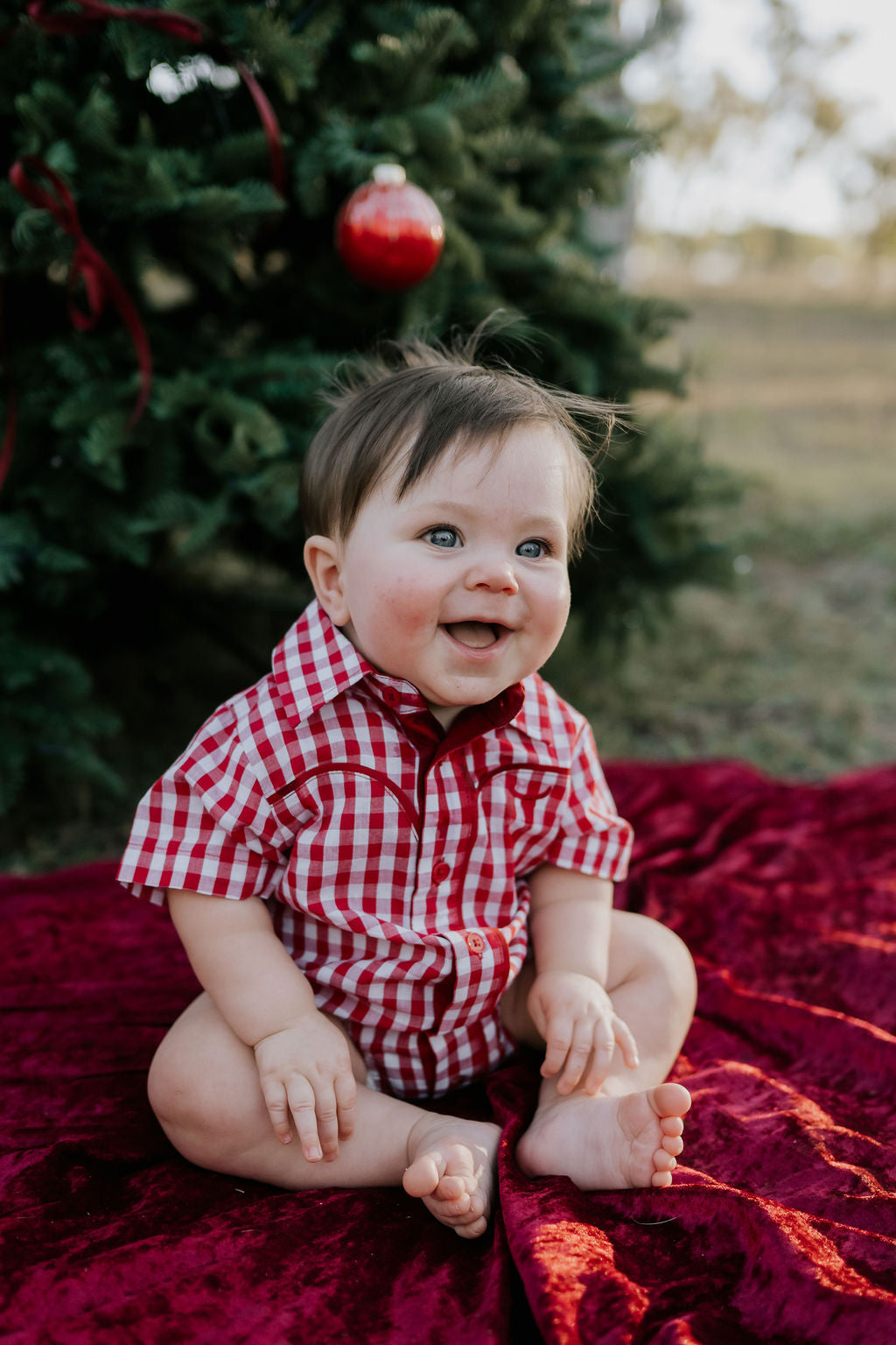 Barnley deep red checked short sleeve romper worn by toddler showing sweet country western style