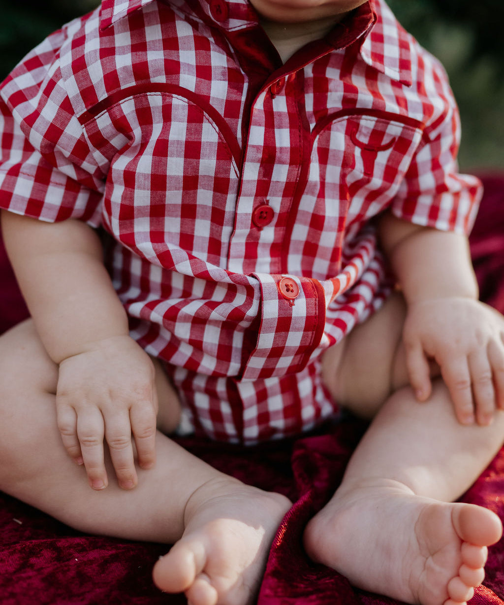 Barnley deep red checked short sleeve romper back view showing snap closure and deep red check fabric