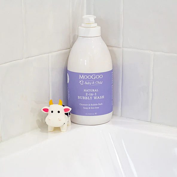 MooGoo Baby 2-in-1 Bubbly Wash 500ml pump bottle in bathroom setting with soft towel