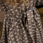 Miley horse print chocolate dress flatlay showing full chocolate horse print dress design