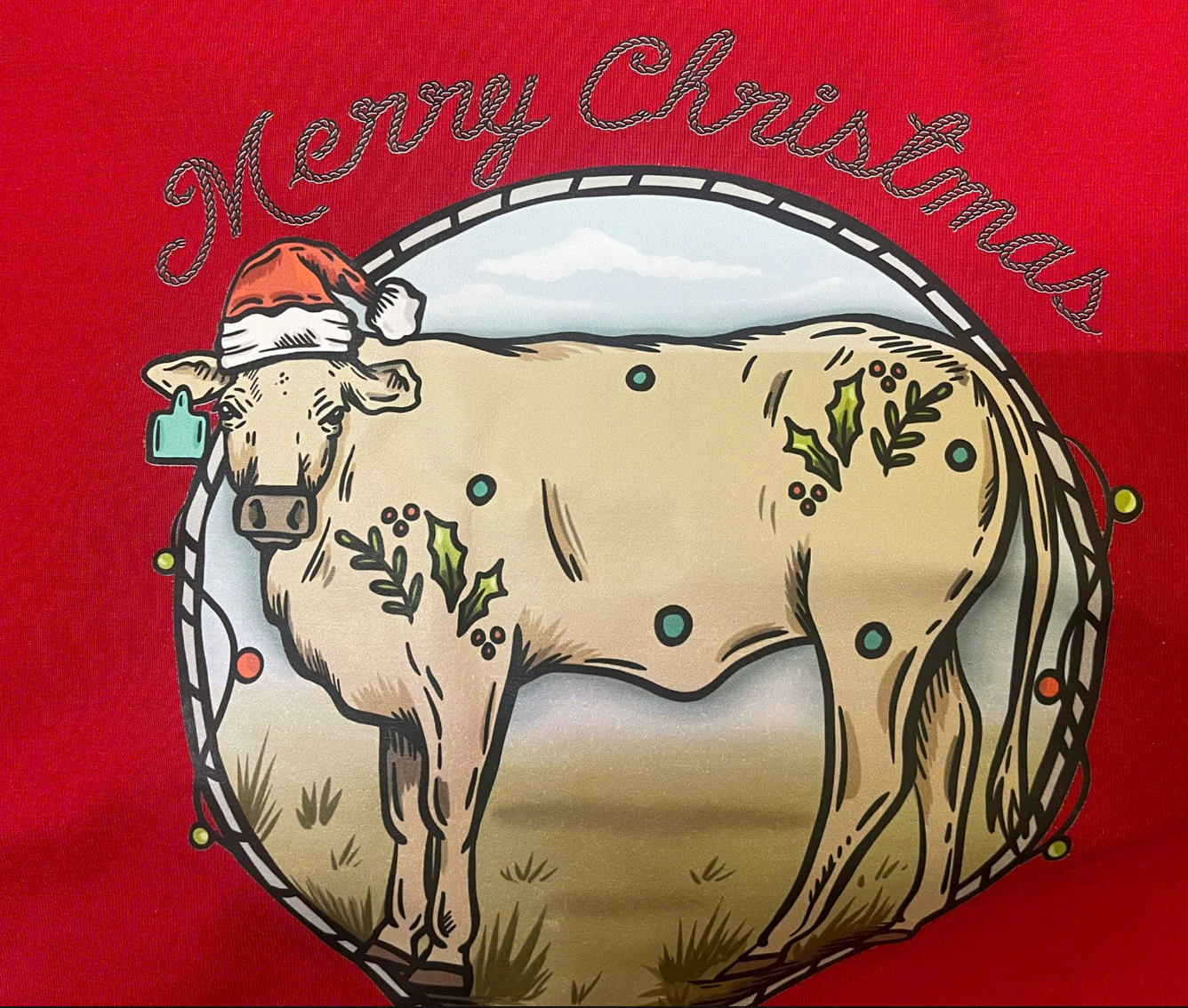 Western printed Christmas cow tee print close-up showing detailed festive cow and Christmas motifs