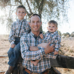Dad and two boys in matching blue plaid shirts