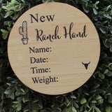 Wooden Ranch Hand Announcement plaque engraved with name, date, time, and weight fields on natural pine background