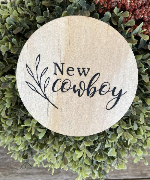 Engraved round cowboy wooden plaque with "New cowboy" text on natural pine wood