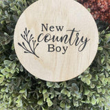 Country boy wooden plaque engraved on natural pine with "New country Boy" text and decorative branch design.