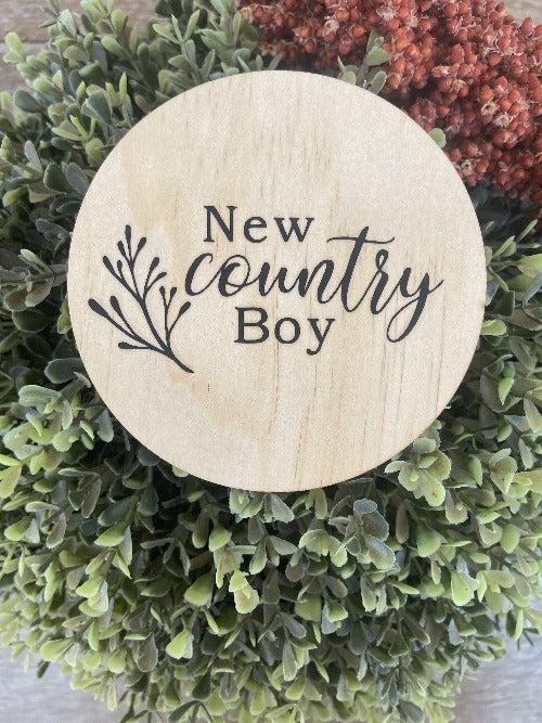 Country boy wooden plaque engraved on natural pine with "New country Boy" text and decorative branch design.